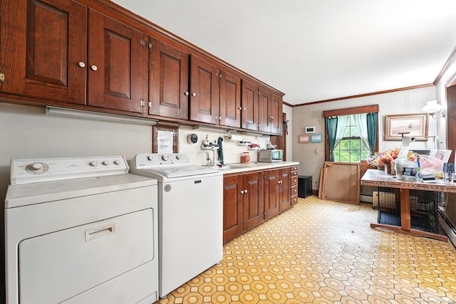 laundry room with separate washer and dryer, cabinet space, ornamental molding, wallpapered walls, and light floors