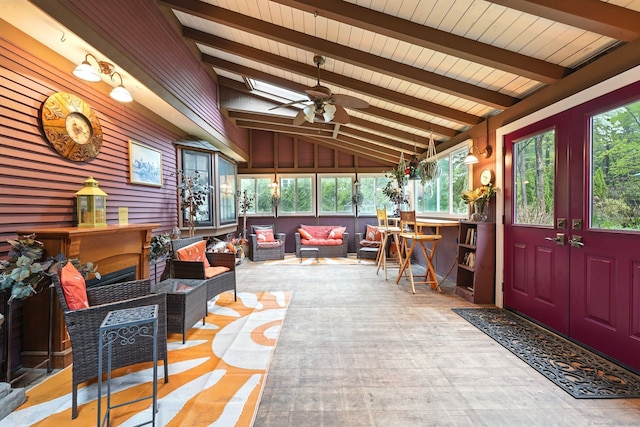 sunroom / solarium with outdoor lounge area, a ceiling fan, and a skylight
