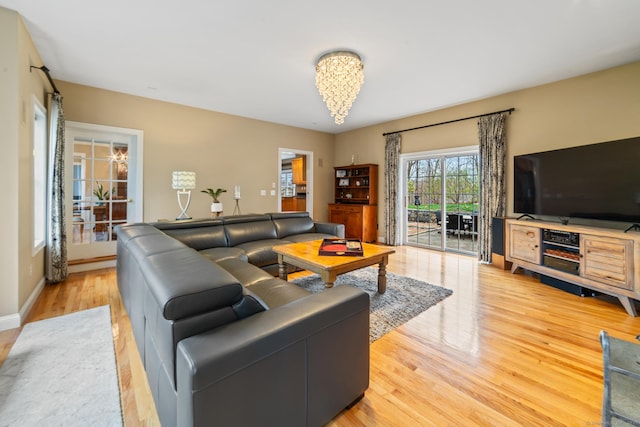24 Scott Rd, Oxford, CT 06478 - living area with a chandelier, light wood-type flooring, and baseboards