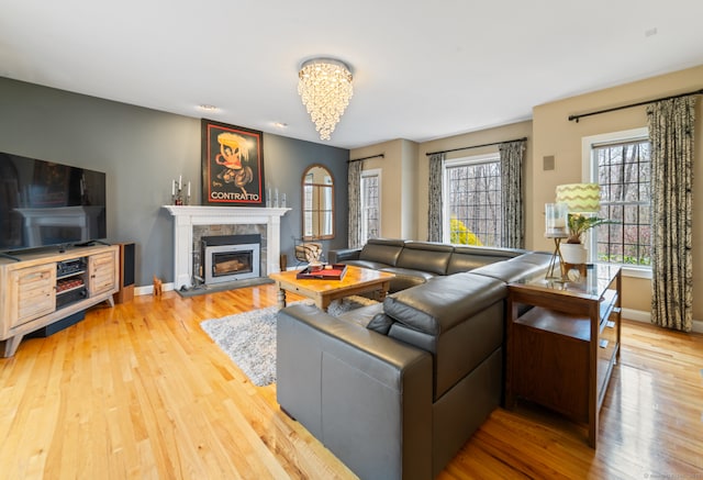 24 Scott Rd, Oxford, CT 06478 - living room featuring light wood-style floors, a tile fireplace, baseboards, and a chandelier