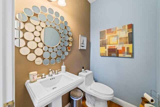 24 Scott Rd, Oxford, CT 06478 - half bathroom with a sink, toilet, and wood finished floors