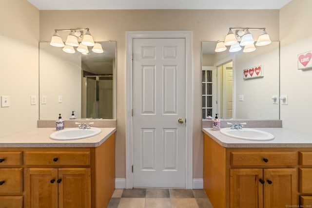 bathroom with a sink, two vanities, and a shower stall