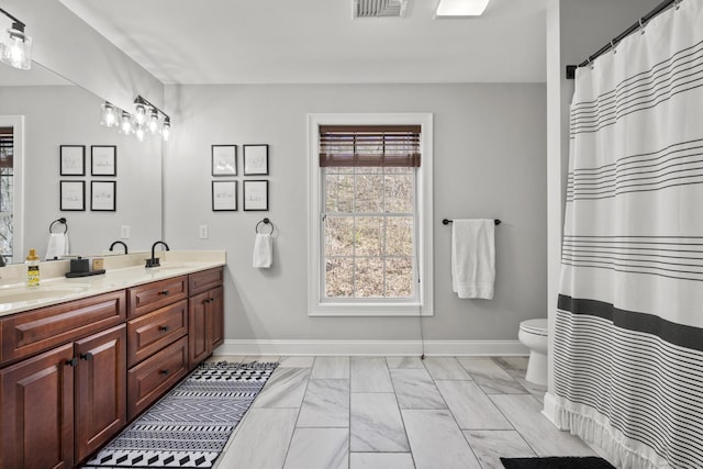 full bathroom with a sink, marble finish floor, visible vents, and baseboards