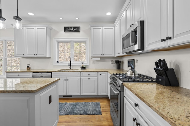 kitchen featuring a sink, white cabinets, and appliances with stainless steel finishes