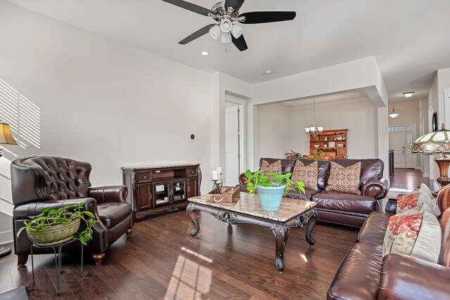 living room with dark wood-style floors and ceiling fan with notable chandelier