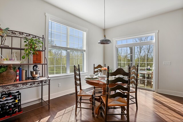 dining room with baseboards and wood finished floors