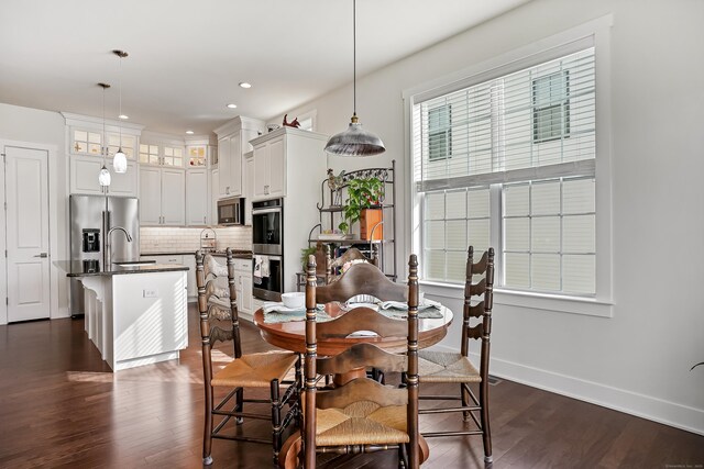 dining room with recessed lighting, dark wood finished floors, and baseboards