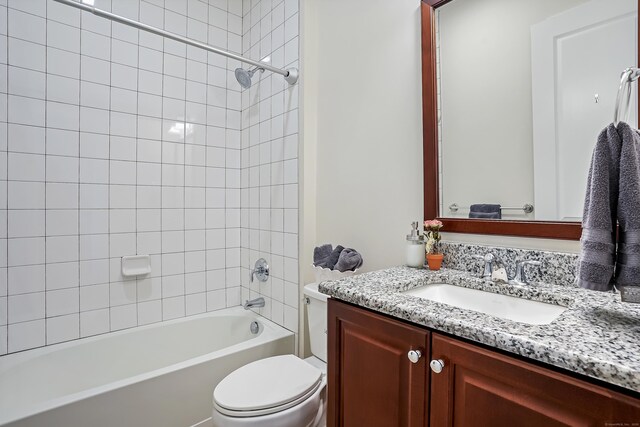 bathroom featuring toilet,  shower combination, and vanity