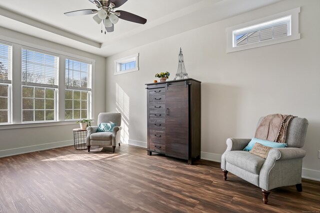 sitting room with a ceiling fan, baseboards, and dark wood-style floors