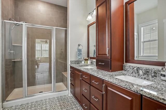 full bathroom with double vanity, a sink, tile patterned floors, and a shower stall