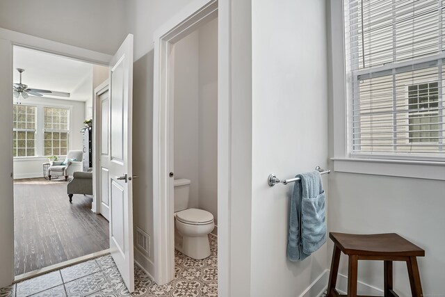 bathroom with visible vents, baseboards, ceiling fan, and toilet