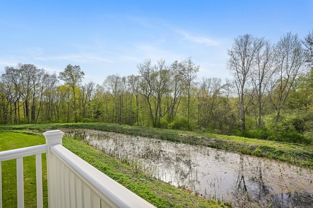 exterior space with a water view and a wooded view