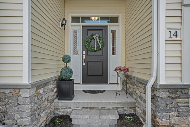 view of exterior entry featuring stone siding