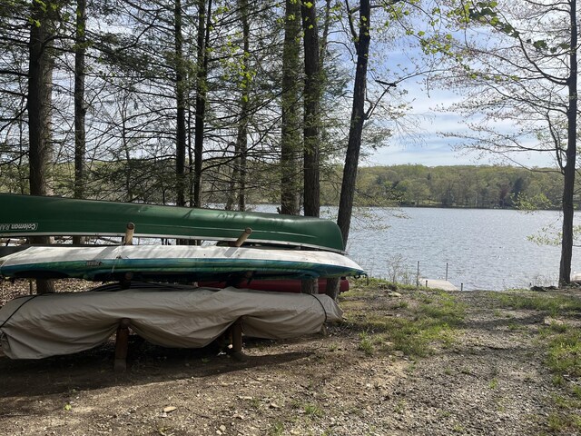 exterior space featuring a water view and a wooded view
