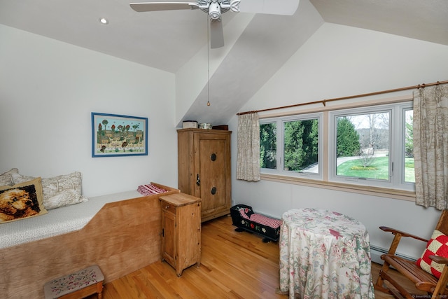 bedroom featuring vaulted ceiling, multiple windows, and light wood finished floors