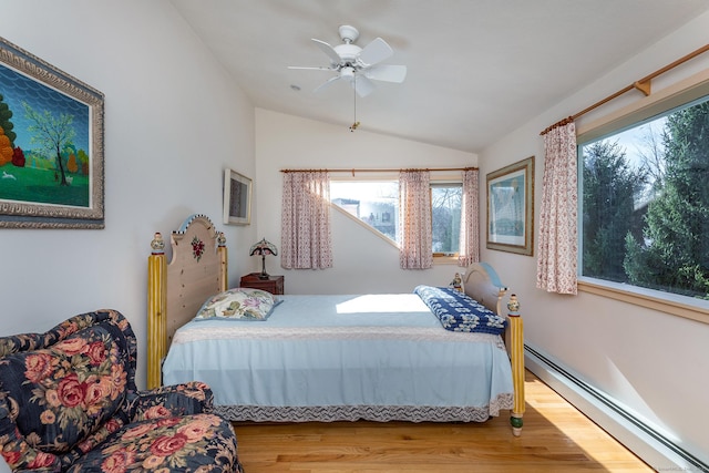 bedroom featuring wood finished floors, a ceiling fan, lofted ceiling, and a baseboard heating unit