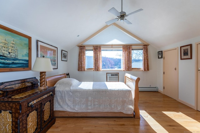 bedroom featuring an AC wall unit, multiple windows, baseboard heating, and light wood-style flooring