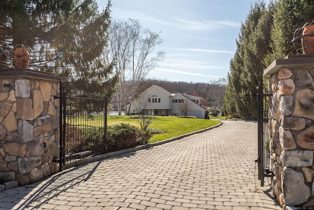 view of gate featuring a lawn