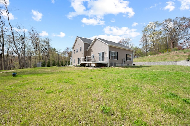 view of side of home with a lawn and a deck
