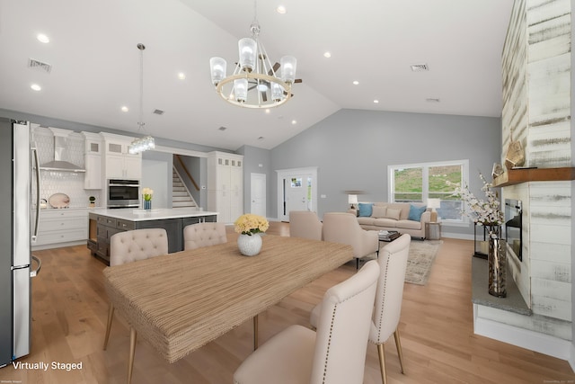 dining area featuring visible vents, recessed lighting, high vaulted ceiling, and an inviting chandelier