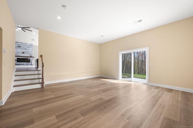 unfurnished living room featuring ceiling fan, visible vents, baseboards, and light wood-style floors