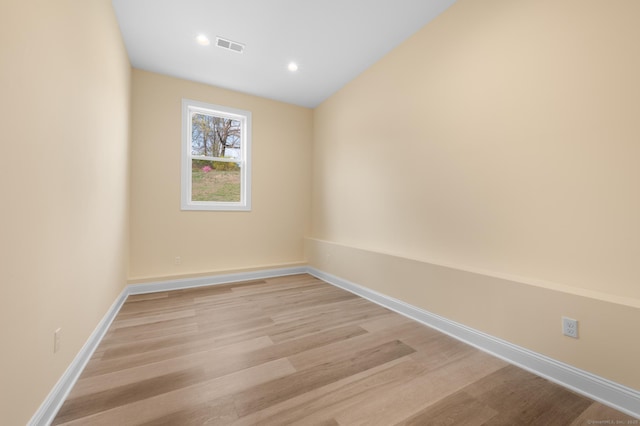 unfurnished room featuring recessed lighting, baseboards, light wood-type flooring, and visible vents