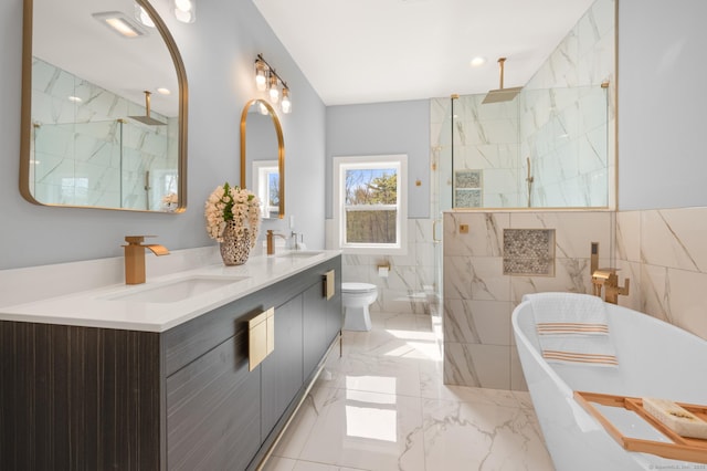 full bathroom with a sink, a marble finish shower, marble finish floor, and a soaking tub