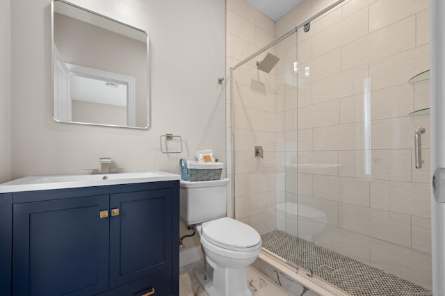 bathroom featuring vanity, a stall shower, and toilet