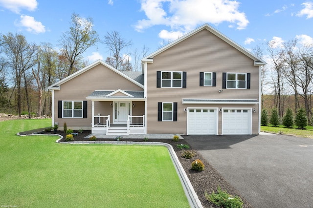 view of front of home featuring a porch, an attached garage, a front yard, and aphalt driveway