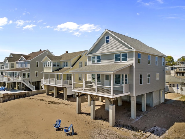 rear view of property with a residential view and a shingled roof