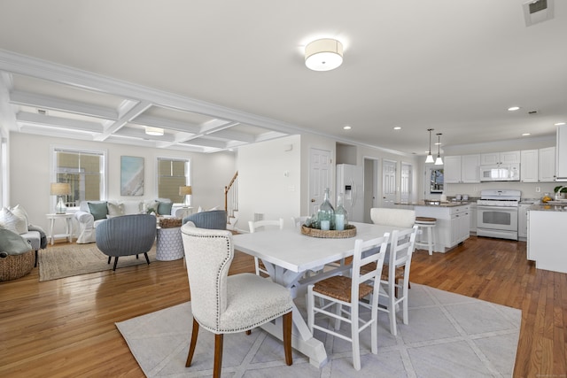 dining area with wood finished floors, visible vents, recessed lighting, beamed ceiling, and coffered ceiling