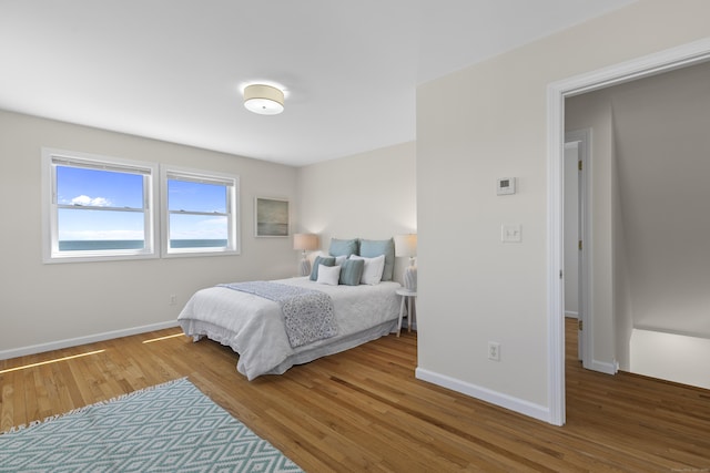 bedroom featuring baseboards and wood finished floors