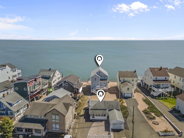bird's eye view featuring a water view and a residential view