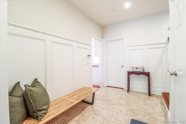 mudroom featuring a wainscoted wall and a decorative wall