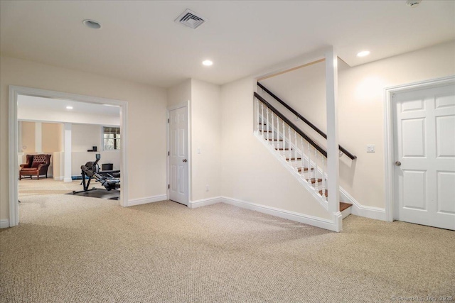 interior space with stairs, visible vents, carpet floors, and baseboards