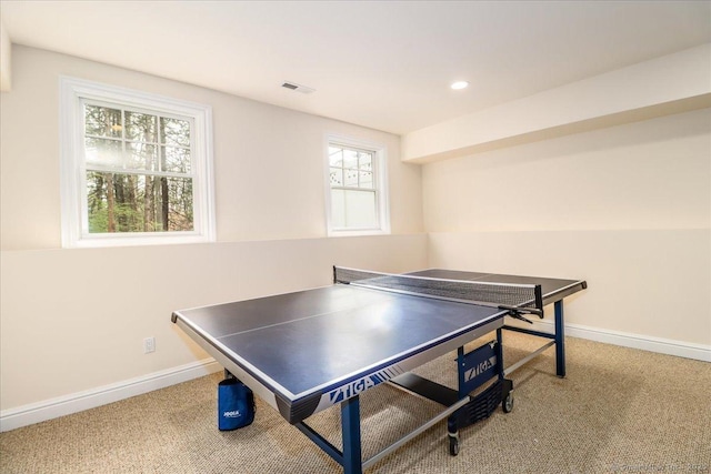 rec room with carpet, a healthy amount of sunlight, and baseboards