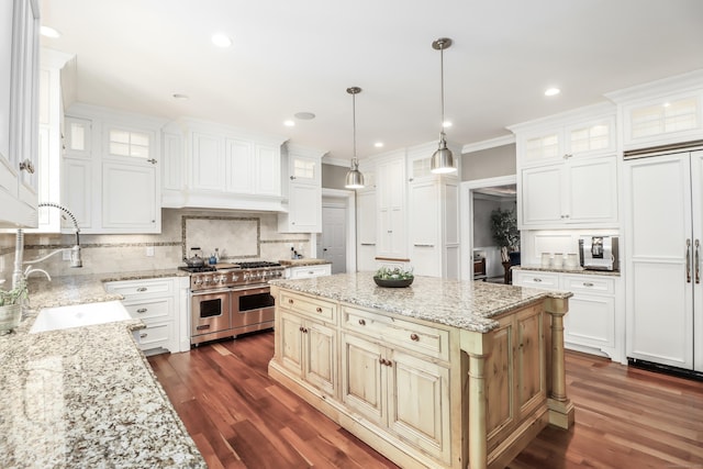 kitchen featuring a center island, dark wood-style floors, high end appliances, and decorative backsplash