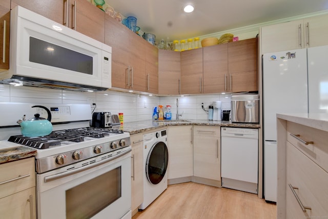 53 E Broadway Unit D, Milford, CT 06460 - kitchen featuring white appliances, light wood-style flooring, light stone counters, decorative backsplash, and washer / dryer