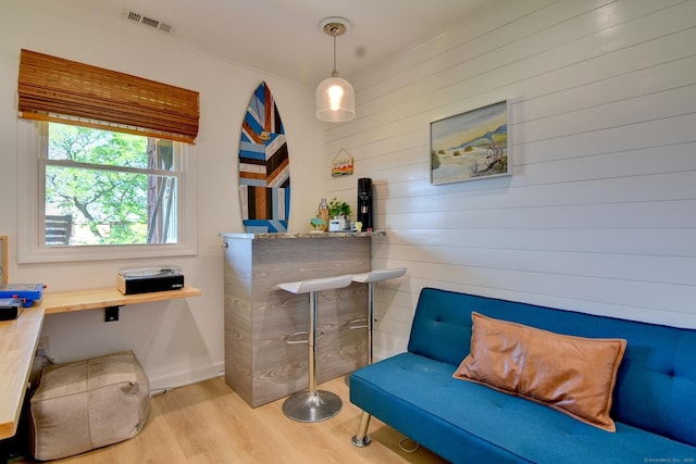 53 E Broadway Unit D, Milford, CT 06460 - sitting room with wooden walls, wood finished floors, visible vents, and baseboards