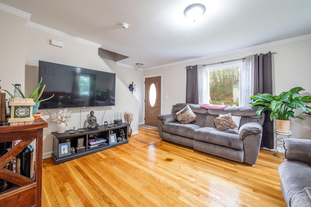 living room featuring crown molding, wood finished floors, and baseboards