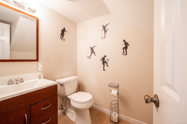 bathroom with tile patterned floors, baseboards, toilet, and vanity