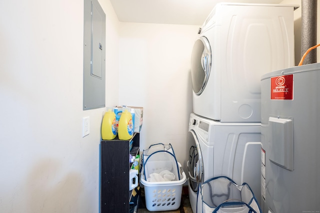 washroom featuring stacked washer and dryer, electric panel, laundry area, and electric water heater