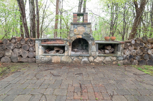 view of patio / terrace featuring exterior fireplace