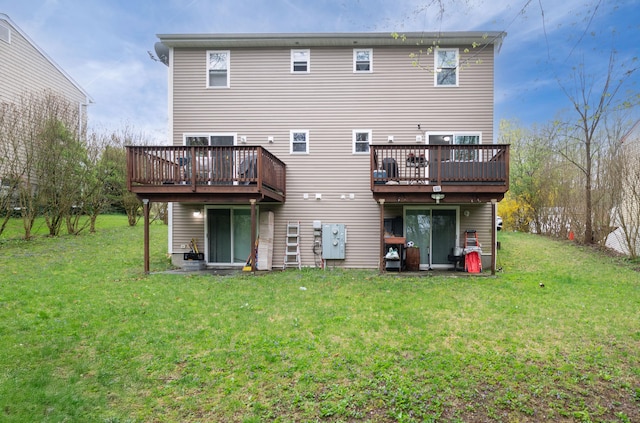 back of house with a lawn and a wooden deck