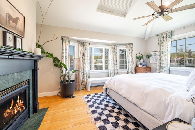 70 N Lake Shore Dr, Brookfield, CT 06804 - bedroom with a fireplace with flush hearth, baseboards, multiple windows, and wood finished floors
