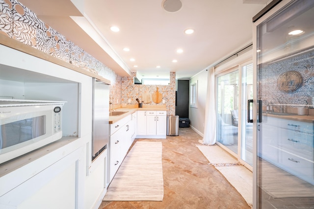 70 N Lake Shore Dr, Brookfield, CT 06804 - kitchen featuring white cabinets, white microwave, light countertops, recessed lighting, and tasteful backsplash