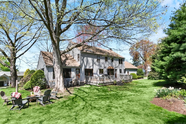 245 Sailors Ln, Bridgeport, CT 06605 - rear view of property with a yard, a wooden deck, and an outdoor fire pit