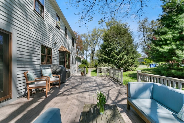 deck with an outdoor living space and area for grilling