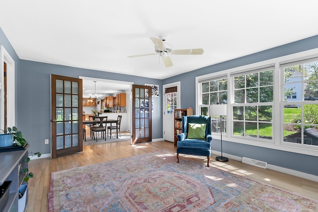 245 Sailors Ln, Bridgeport, CT 06605 - living area featuring visible vents, wood finished floors, baseboards, french doors, and ceiling fan with notable chandelier