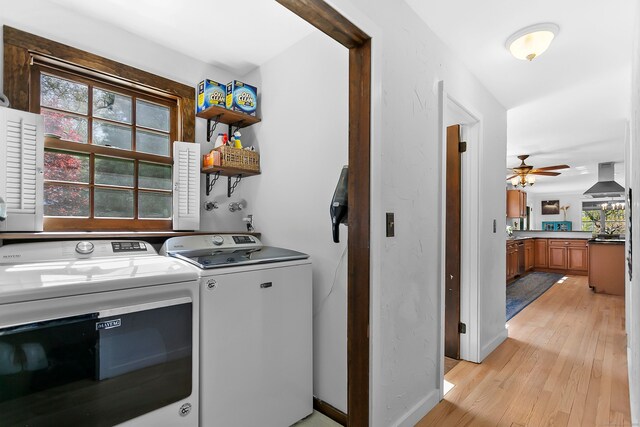 laundry room featuring laundry area, washer and dryer, baseboards, ceiling fan, and light wood finished floors